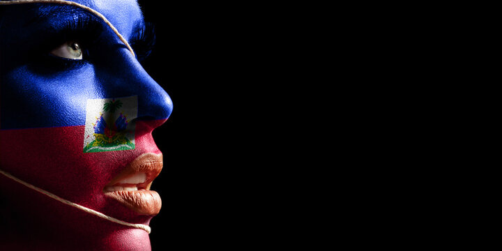 Haiti flag painted on a face of a young woman, national flag