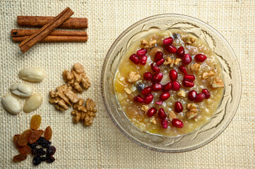 Ashure or Noah's pudding, the turkish dessert porridge in glass bowl on natural matting