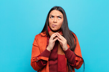 latin woman scheming and conspiring, thinking devious tricks and cheats, cunning and betraying