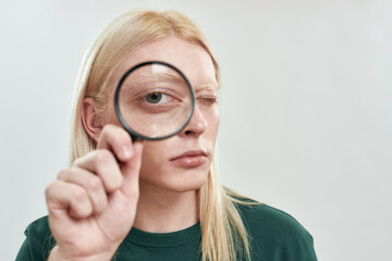 Portrait of young caucasian man with enlarged eye