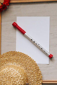 Ukrainian flute with a sheet of paper with a straw hat and a wooden frame