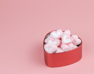 heart shape marshmallow in red heart shape box on pink background with copy space. Valentine's day concept.