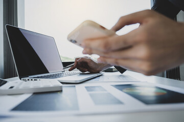 Businesswoman hand holding pen, analysis the graph with calculator and laptop at the home office for setting challenging business goals And planning to achieve the new target