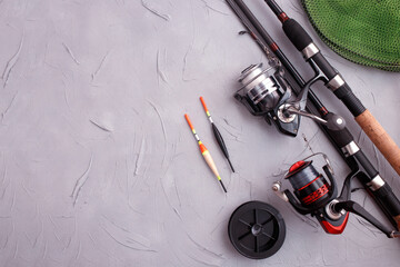 Fishing equipment composition concept. Rod, float on a gray background. Flat lay, top view, copy space. - obrazy, fototapety, plakaty
