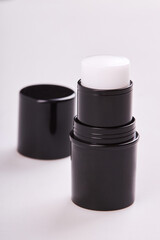 Face primer in a black tube isolated on white. Perfecting face base in mini stick format