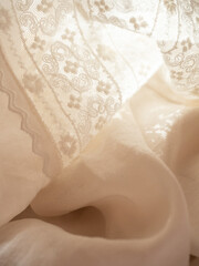 Delicate milky lace with a string of baroque pearls in the morning sun