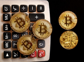 Close up of gold bitcoin on black background with selective focus