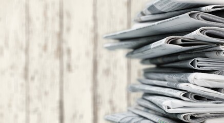 Pile of newspapers stacks on blur background