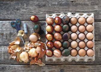 The concept of preparing for the Easter holiday. Painted eggs on a wooden background.