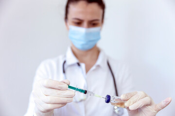 A doctor or scientist holding a syringe with liquid vaccines for children or elderly adults....