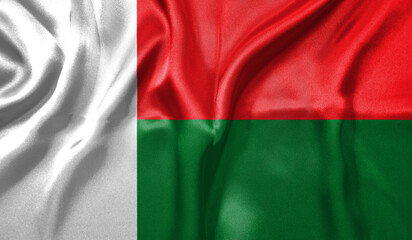 Madagascar flag wave close up. Full page Madagascar flying flag. Highly detailed realistic 3D rendering