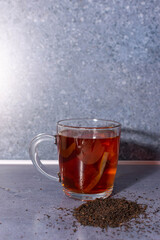 cup of tea with tea leaves on the side