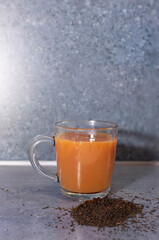 cup of coffee with tea leaves on the side