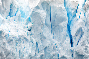 Ice sculptured at the glaciers edge, with the deep blue of the crevasses contrasting with the white...