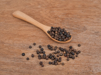 Black pepper on the wooden