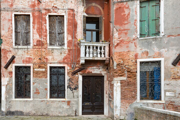 Weathered facade of a typical Venetian residential home, Venice, Italy