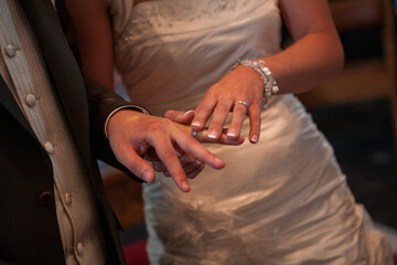 An unrecognizable bride and groom exchanging of the Wedding Rings in church during the christian wedding ceremony . High quality photo