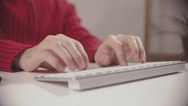 a person types on a keyboard