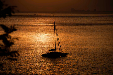 Sail boat and sunset light at lanta beach Thailand