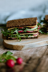 Food still life, fresh whole grain bread with cheese, radish, cucumber, arugula, healthy food, superfood