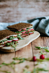 Food still life, fresh whole grain bread with cheese, radish, cucumber, arugula, healthy food, superfood