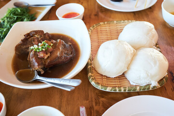 Mantou or Chinese steam buns and boiled pork leg