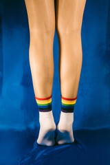 Woman with LGTB socks with blue background