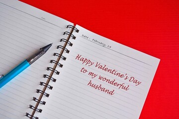 Text on white notepad with red background. Valentine's day concept