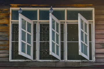 Pigeons on old wooden window of the former wooden house.