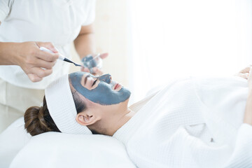 Skin Care. woman are masking her face in a spa salon. Woman with cosmetic spa facial mask.