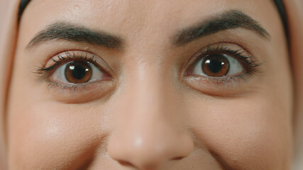 Portrait of the happy eyes of a woman wearing a headscarf.