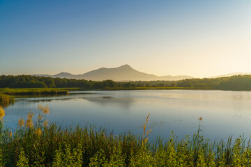 The sunrise in the morning with mountain, lake and sky at Mae Moh, Lampang, Thailand.