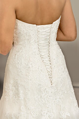 Backside of a bride in her wedding gown with beautiful lacing