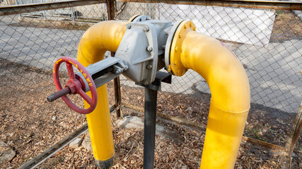 Backbone pipe with valve painted in yellow, for the transportation of natural gas.
