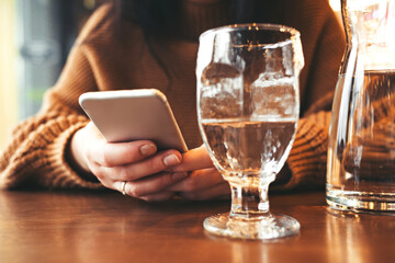 Girl working on a smartphone in a cafe