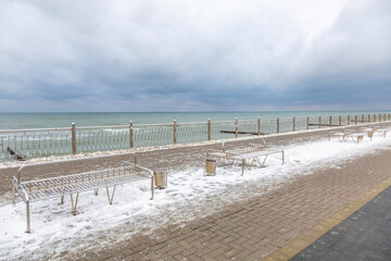 A recreation bench for tourists in the resort town on a winter day