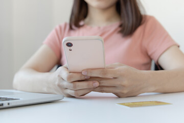 Close-up image of woman's hand holding a phone or smartphone For internet and entertainment or to relax after working in the office, Technology communication and internet networking.