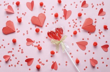 Valentine's day flat lay photography with heart shape lollipops on a pink background. Romantic greeting card 