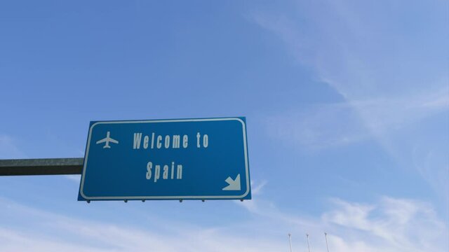 airplane flying over welcome to spain  billboard boarder road sign,welcoming travel claim concept