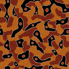 Seamless vector pattern including ethnic Australian motive with dotted different elements on orange background