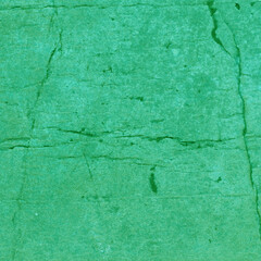 Cardboard green abstract pattern texture close-up. Retro old paper background. Grunge concrete wall. Vintage blank wallpaper.