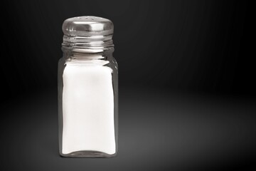 The salt glass bottle on the dark background