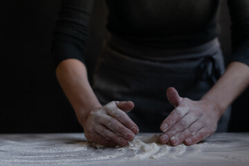 Obraz na płótnie Canvas Woman baker with flour in her hands