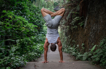 Man practice Yoga outdoor. Practice and meditation in jungle.