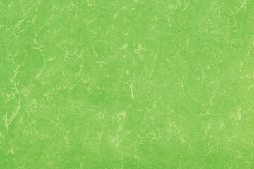 Cardboard green abstract pattern texture close-up. Retro old paper background. Grunge concrete wall. Vintage blank wallpaper.