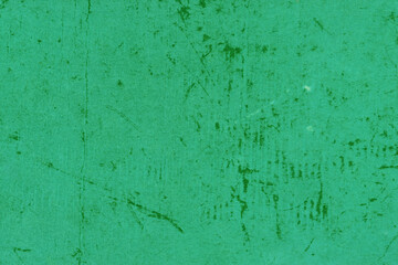 Cardboard green abstract pattern texture close-up. Retro old paper background. Grunge concrete wall. Vintage blank wallpaper.