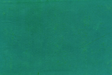 Cardboard green abstract pattern texture close-up. Retro old paper background. Grunge concrete wall. Vintage blank wallpaper.