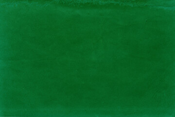 Cardboard green abstract pattern texture close-up. Retro old paper background. Grunge concrete wall. Vintage blank wallpaper.