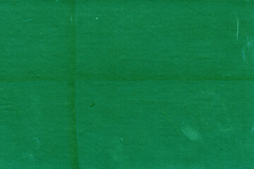 Fototapeta premium Cardboard green abstract pattern texture close-up. Retro old paper background. Grunge concrete wall. Vintage blank wallpaper.