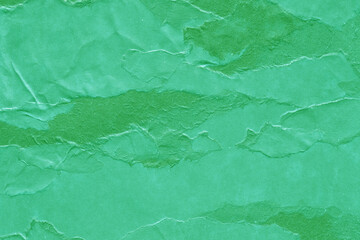 Cardboard green abstract pattern texture close-up. Retro old paper background. Grunge concrete wall. Vintage blank wallpaper.